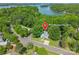 Aerial view of 9012 Windjammer Drive lakeside home surrounded by lush greenery and serene waters at 9012 Windjammer Dr, Tega Cay, SC 29708