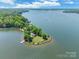 Serene aerial image capturing a waterfront estate with a private dock and verdant surroundings at 9012 Windjammer Dr, Tega Cay, SC 29708