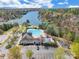 Aerial view of community pool, splash pad, and playground near a lake and boat docks at 9012 Windjammer Dr, Tega Cay, SC 29708