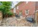 Private back patio with stone floor, dining table, grill, and lush landscaping at 984 Park Slope Dr, Charlotte, NC 28209