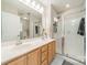 Bathroom features a double sink vanity with a white countertop and a glass enclosed shower at 984 Park Slope Dr, Charlotte, NC 28209