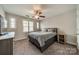 Bedroom featuring three windows, neutral tones, carpeted floors, and a full bed frame at 984 Park Slope Dr, Charlotte, NC 28209