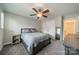 Bedroom featuring neutral tones, carpeted floors, and a full bed frame with ceiling fan at 984 Park Slope Dr, Charlotte, NC 28209