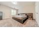 Bedroom featuring neutral tones, carpeted floors, and a full bed frame with storage at 984 Park Slope Dr, Charlotte, NC 28209