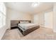 Modern bedroom featuring a platform bed, plush carpet, and minimalist design creating a serene space at 984 Park Slope Dr, Charlotte, NC 28209