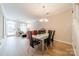 Open concept dining room and living room with stylish chandelier and staircase at 984 Park Slope Dr, Charlotte, NC 28209