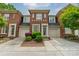 Charming brick townhouse with a well-manicured lawn and attached garages at 984 Park Slope Dr, Charlotte, NC 28209
