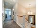 Upstairs hallway with carpet, white banister, and chandelier at 984 Park Slope Dr, Charlotte, NC 28209