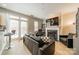 Living room features a fireplace, black leather sofa, and doors to the patio at 984 Park Slope Dr, Charlotte, NC 28209