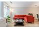 Comfortable living room with modern orange sofa, hardwood floors, and neutral walls at 984 Park Slope Dr, Charlotte, NC 28209