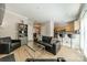 Open-concept living room flows into kitchen with barstools, black couch, and fireplace at 984 Park Slope Dr, Charlotte, NC 28209