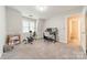 Spare room featuring carpeted floors, an exercise bike, and a desk with monitors at 984 Park Slope Dr, Charlotte, NC 28209
