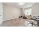 Spare room featuring carpeted floors, an exercise bike, and a desk with monitors at 984 Park Slope Dr, Charlotte, NC 28209