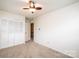 A bright bedroom with a ceiling fan and a large closet with bi-fold doors for ample storage at 1025 Hefner Nw Dr, Conover, NC 28613