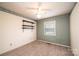 This bedroom has wallpaper, plush carpet, open shelves and a window with blinds at 1025 Hefner Nw Dr, Conover, NC 28613