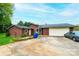 A single-story home has brown siding, a large driveway and an attached garage, offering both practicality and charm at 1025 Hefner Nw Dr, Conover, NC 28613