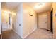 Well-lit hallway with neutral paint, plush carpeting, and a view of other rooms in the home at 1025 Hefner Nw Dr, Conover, NC 28613