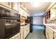 Well-lit kitchen featuring black appliances and retro style backsplash at 1025 Hefner Nw Dr, Conover, NC 28613