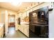 The kitchen offers black appliances, ample counter space, and vintage wallpaper at 1025 Hefner Nw Dr, Conover, NC 28613