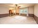 Spacious living room with natural lighting, ceiling fan, carpeted floors, and views of the yard at 1025 Hefner Nw Dr, Conover, NC 28613