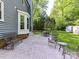 Backyard featuring a large stone patio, iron furniture, and manicured landscaping at 104 Aurora Ln, Huntersville, NC 28078