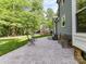 Spacious backyard featuring a stone patio, outdoor seating, and well-maintained lawn at 104 Aurora Ln, Huntersville, NC 28078