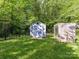 Fenced backyard featuring a shed and a climbing wall, offering outdoor activities and storage at 104 Aurora Ln, Huntersville, NC 28078