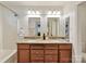 Bathroom with double vanity, granite counters, wood cabinets, and tub/shower combo at 104 Aurora Ln, Huntersville, NC 28078