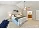Primary bedroom with vaulted ceiling, ceiling fan, neutral carpet and walls at 104 Aurora Ln, Huntersville, NC 28078