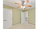 Bedroom featuring neutral walls, carpet, closet, and open door to the upstairs hallway at 104 Aurora Ln, Huntersville, NC 28078