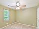 Bright bedroom featuring a ceiling fan, window, and neutral carpet and walls at 104 Aurora Ln, Huntersville, NC 28078