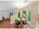 Breakfast nook with natural light, wood floors, and view of the fireplace at 104 Aurora Ln, Huntersville, NC 28078