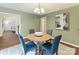Charming dining area featuring a round table, seating for four, and a view of the living area at 104 Aurora Ln, Huntersville, NC 28078