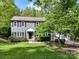 Charming two-story home with lush landscaping, a well-maintained lawn, and a welcoming entrance at 104 Aurora Ln, Huntersville, NC 28078