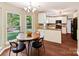 Eat-in kitchen with stainless appliances, granite counters, and breakfast nook overlooking backyard at 104 Aurora Ln, Huntersville, NC 28078
