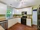 Well-lit kitchen featuring white cabinets, granite countertops, and stainless steel appliances at 104 Aurora Ln, Huntersville, NC 28078