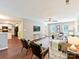Open-concept living room with kitchen access, hardwood floors, and abundant natural light at 104 Aurora Ln, Huntersville, NC 28078