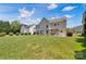 Spacious backyard featuring well-maintained grass, trees, and a charming patio area at 105 Runningdeer Dr, Mooresville, NC 28117