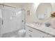 Bright bathroom featuring a glass shower door, marble countertops, and a decorative round mirror at 105 Runningdeer Dr, Mooresville, NC 28117