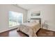 Cozy bedroom with a large window, wood flooring and neutral color scheme at 105 Runningdeer Dr, Mooresville, NC 28117