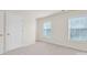 Neutral bedroom with two windows allowing for lots of natural light and neutral carpet at 105 Runningdeer Dr, Mooresville, NC 28117