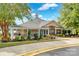 A beautifully landscaped clubhouse, with manicured shrubs, features white columns and covered entry at 105 Runningdeer Dr, Mooresville, NC 28117