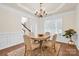 Formal dining room with hardwood floors, wainscoting and a chandelier at 105 Runningdeer Dr, Mooresville, NC 28117