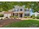 Two-story home featuring a brick and siding exterior, complemented by a well-manicured front yard and a two-car garage at 105 Runningdeer Dr, Mooresville, NC 28117