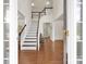 Elegant foyer with hardwood floors, a staircase, and natural light creating a welcoming entrance to the home at 105 Runningdeer Dr, Mooresville, NC 28117