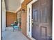Inviting front porch with a stylish dark-brown front door, brick accents, and a cozy seating area for relaxing at 105 Runningdeer Dr, Mooresville, NC 28117