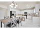 Open kitchen with stainless steel appliances, island with seating, and adjacent dining table at 105 Runningdeer Dr, Mooresville, NC 28117