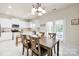 Bright kitchen features white cabinetry, stainless steel appliances and adjacent dining area at 105 Runningdeer Dr, Mooresville, NC 28117