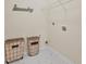 Functional laundry room with shelving, laundry baskets and tile floor at 105 Runningdeer Dr, Mooresville, NC 28117