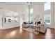 Spacious living room with high ceilings, natural light, hardwood floors, fireplace, and open concept to the kitchen at 105 Runningdeer Dr, Mooresville, NC 28117